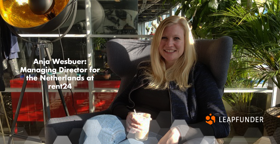 A blonde girl sitting in a chair with a drink in her hand