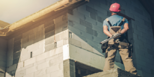 Construction worker in front of a construction site