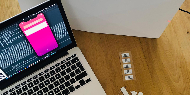 A Mac laptop on a table next to a box