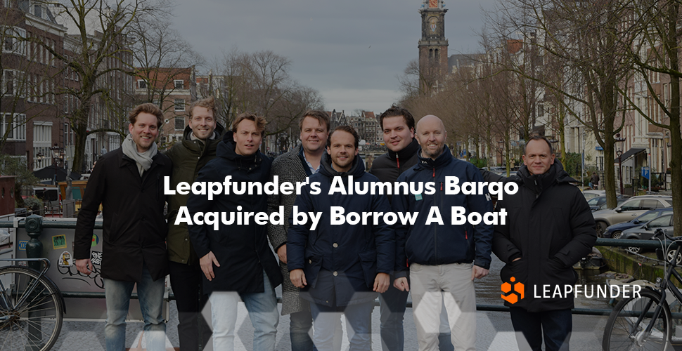 A group of men standing on a bridge in Amsterdam, posing for a photo